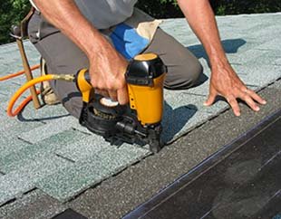 South Creek Roofing & Waterproofing Inc. Roofing Services - Contractor replacing and installing shingles